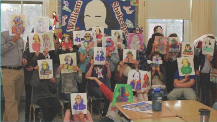 Rob Bell and his class of students holding their drawings of Shakespeare in front of their faces.